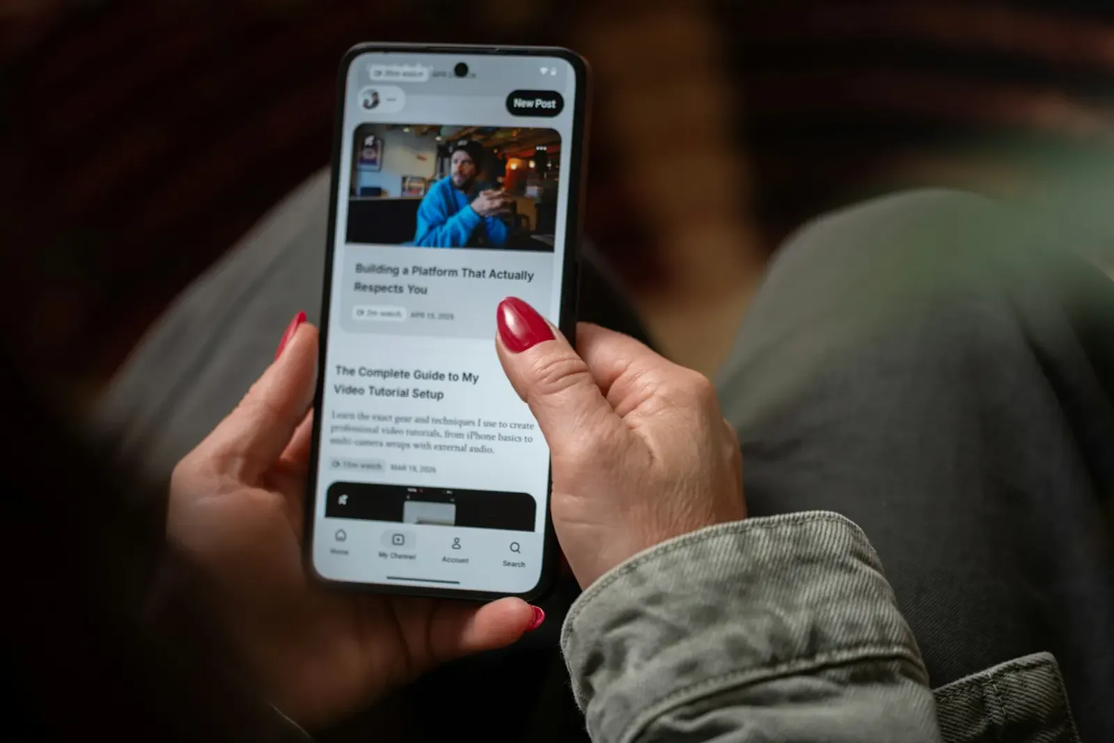 Hand holding a smartphone displaying an article page