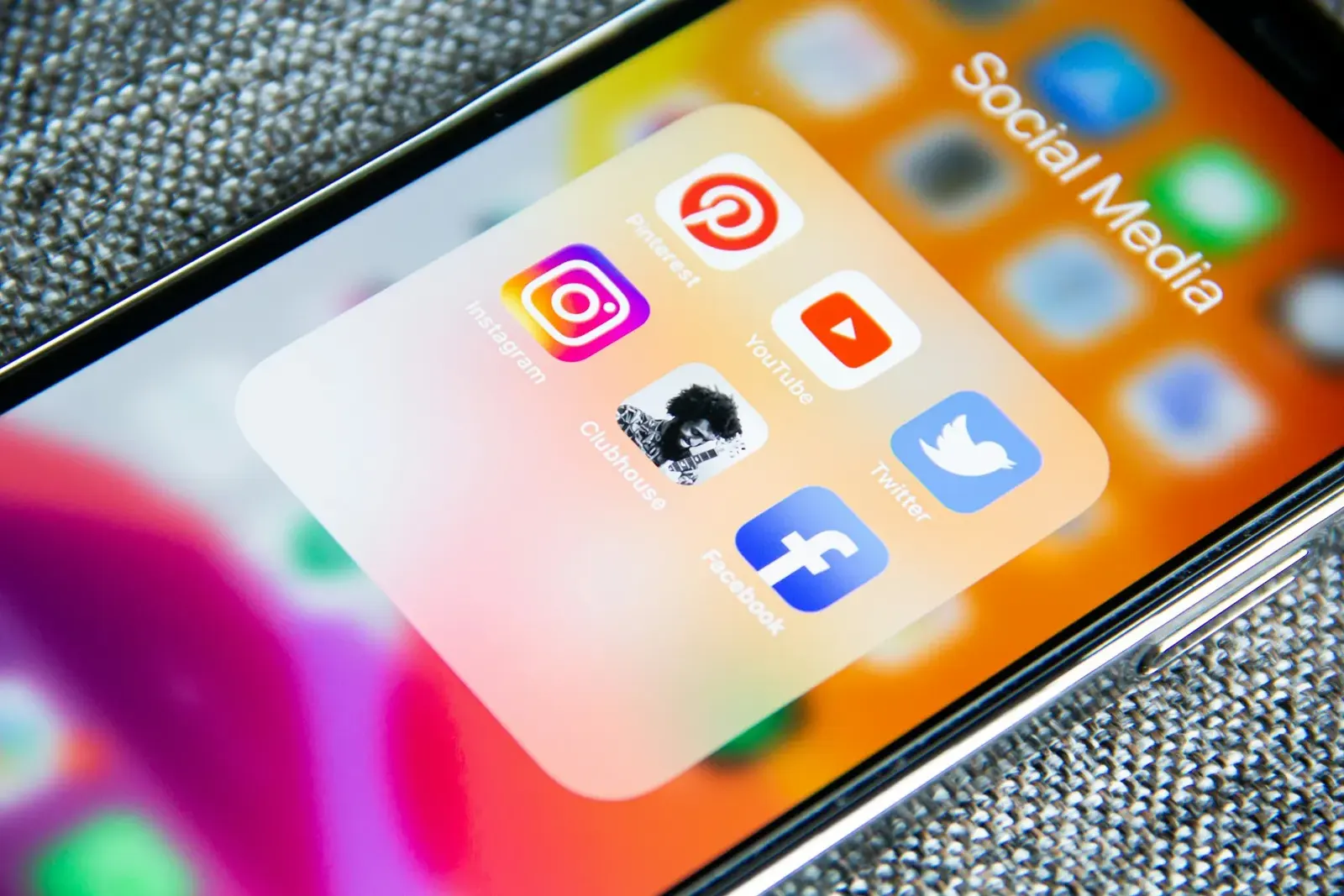 Smartphone screen with a folder of social media app icons
